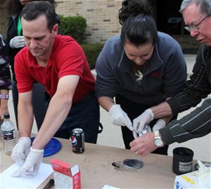 Fall Citizens Academy attendees working at a table while wearing gloves.